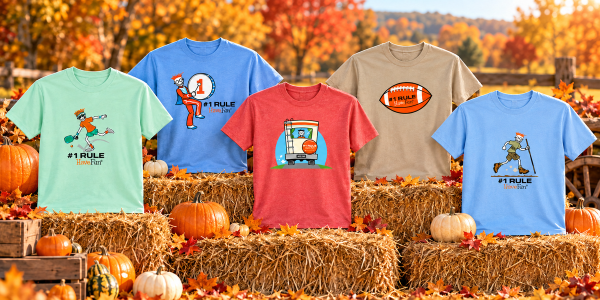 Five HaveFun activity shirts displayed on hay bales among pumpkins and autumn leaves.